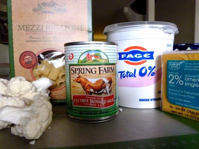Ingredients for making cauliflower mac and cheese including: cauliflower florets, rigatoni pasta, fat-free evaporated skim milk, non-fat Greek yogurt and reduced-fat American cheese