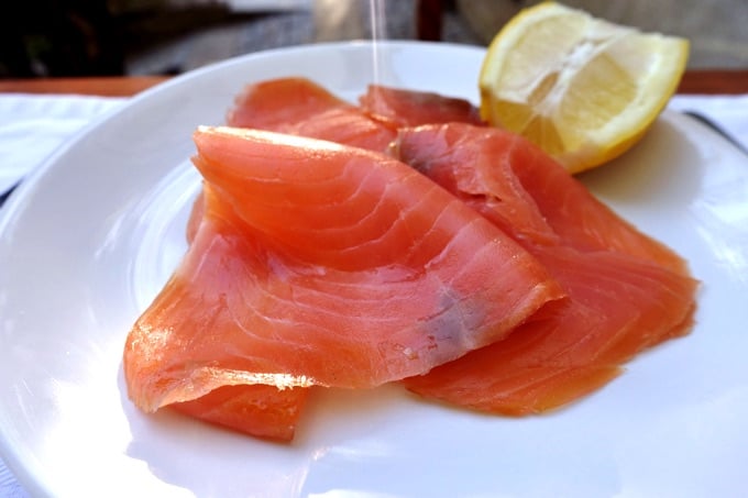 Smoked Salmon on small white plate with lemon.