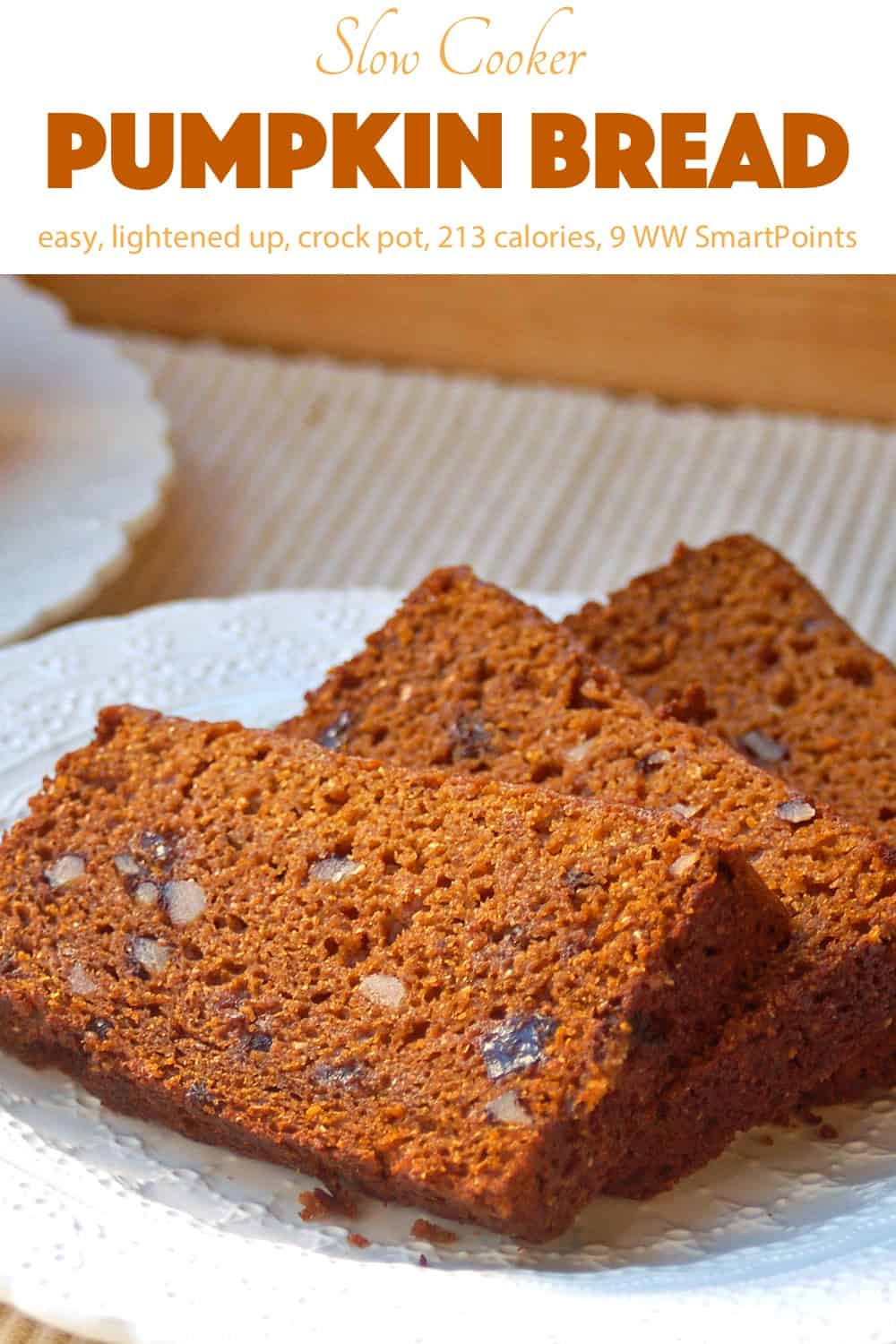 Fresh sliced pumpkin bread with raisins and nuts on a white plate.