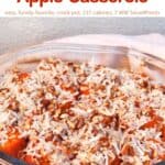 Slow cooker sweet potato apple casserole topped with chopped pecans and shredded coconut in glass serving dish.