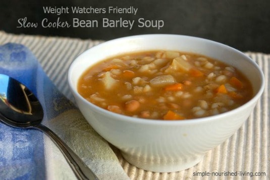 Bean Barley Soup in white bowl with spoon.
