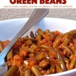 Creole-Style Slow Cooker Green Beans in white serving dish with spoon.