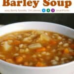 Slow cooker bean and barley soup in white bowl up close.