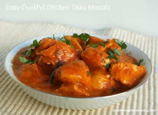 Slow Cooker Chicken Tikka Masala garnished with fresh cilantro in white serving bowl.