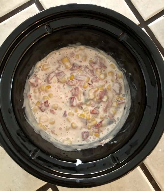 Cooked cheesy corn dip in slow cooker.