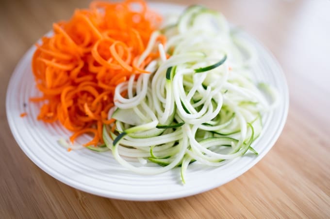 Carrot Noodles and Zucchini Noodles on a white plate