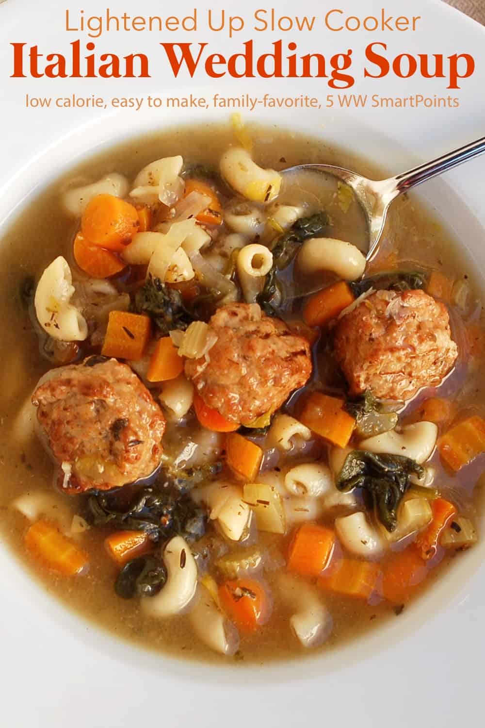 Slow Cooker Italian Wedding Soup in white bowl with spoon from above.