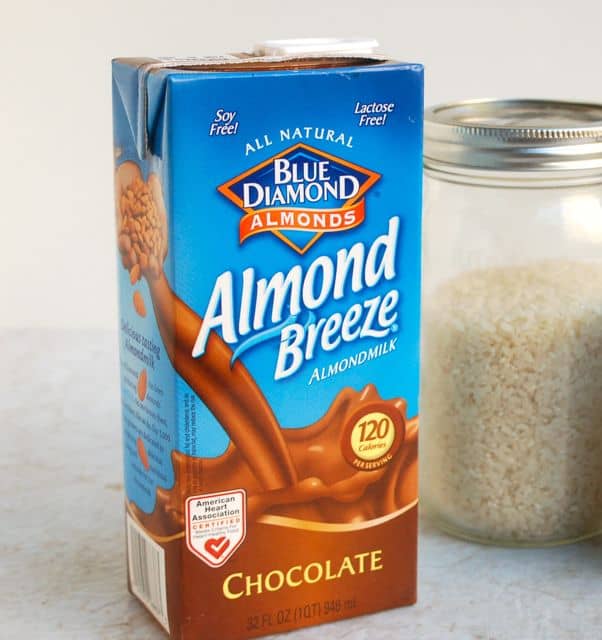Chocolate Almond Breeze Almond Milk container next to jar with arborio rice.