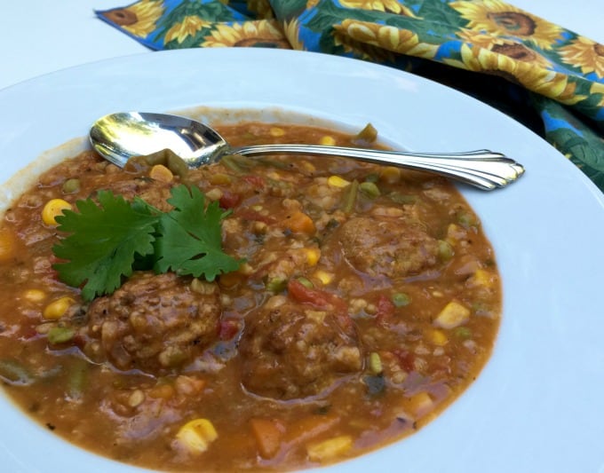 Bowl of mexican meatball soup with spoon.