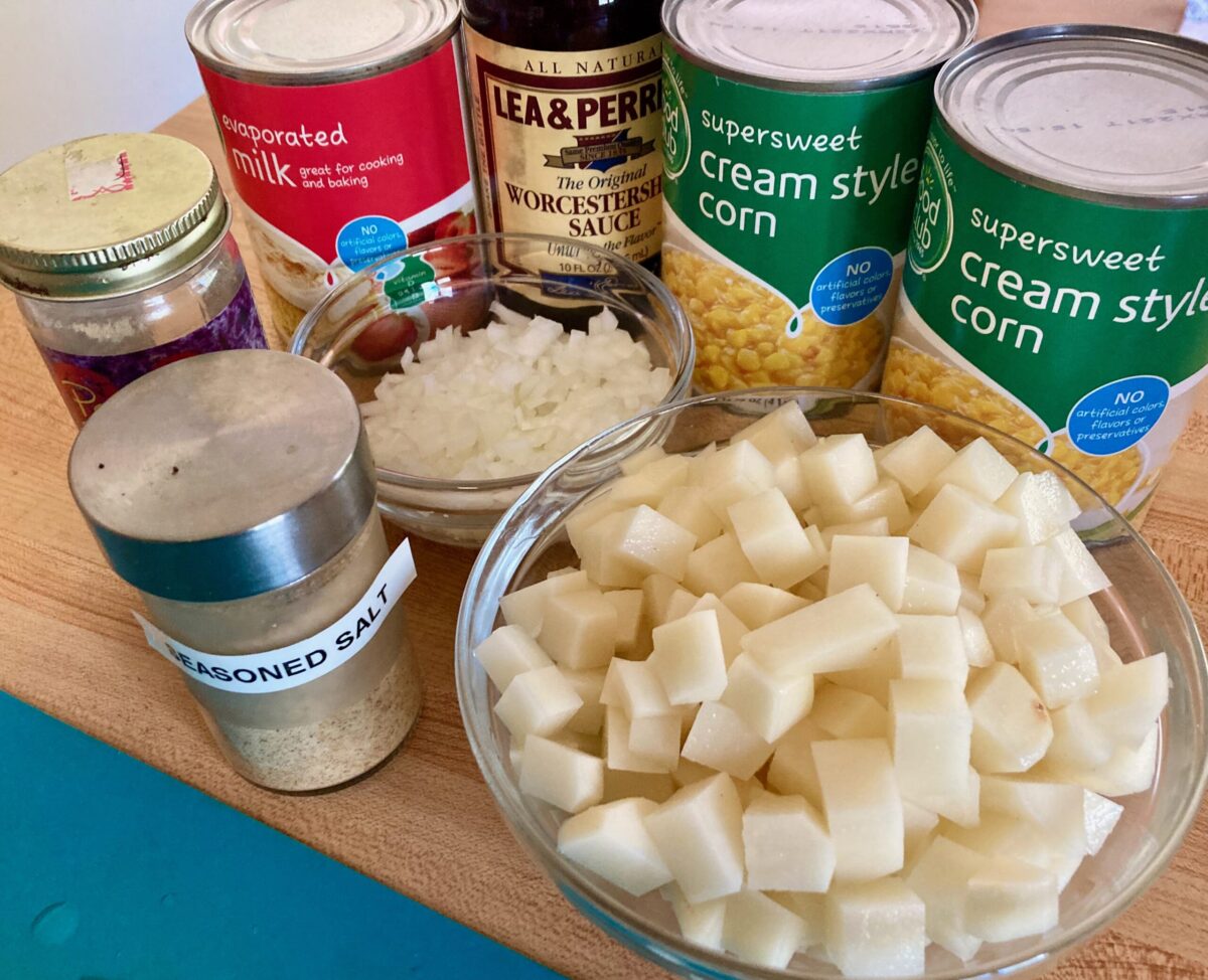 Corn Chowder Ingredients including canned corn, diced potatoes, diced onion, evaporated milk and seasonings.