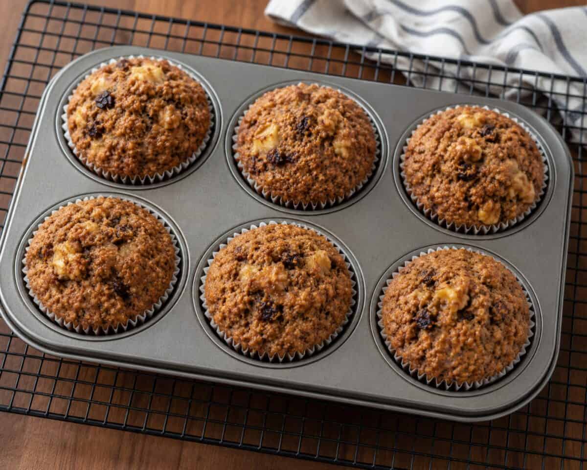 Chunky Banana Bran Muffins in a 6-cup muffin pan on a wire rack.
