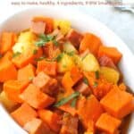 Cubed ham, sweet potatoes and pineapple in white casserole dish with serving spoon