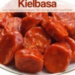 Slow cooker sweet and sour kielbasa on white serving plate.
