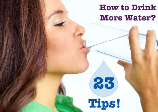 Profile of woman wearing green blouse drinking glass of water