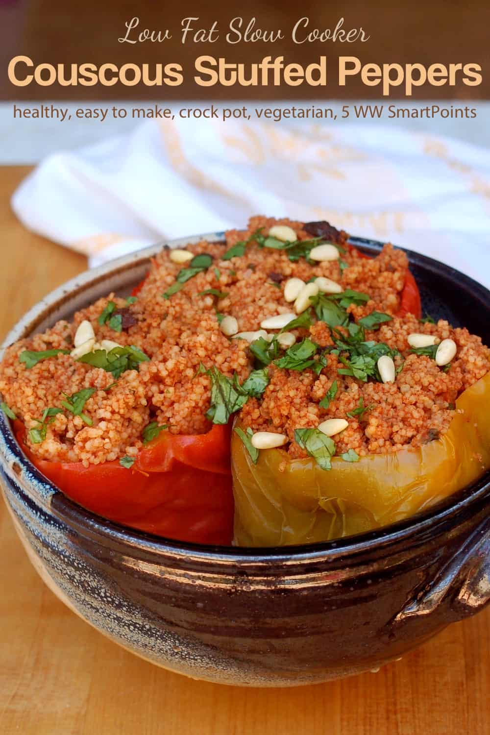 Three slow cooker couscous stuffed peppers in blue ceramic dish.