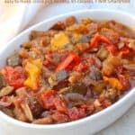 Ratatouille with eggplant, zucchini, peppers, onions and tomatoes in white serving dish