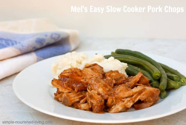 Slow Cooker Pork Chops with mashed potatoes and green bean in white dinner plate.