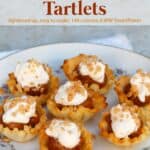 Easy 4-ingredient dulce de leche tartlets garnished with whipped topping and Heath bits.