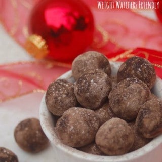 Weight Watchers No Bake Peanut Buttery Cookie Dough Balls arranged in a bowl with red ribbon christmas balls background