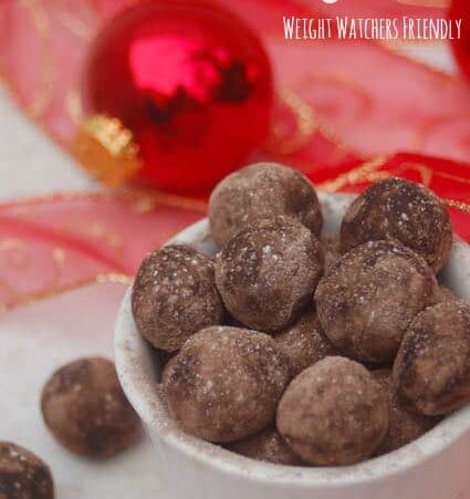 Weight Watchers No Bake Peanut Buttery Cookie Dough Balls arranged in a bowl with red ribbon christmas balls background