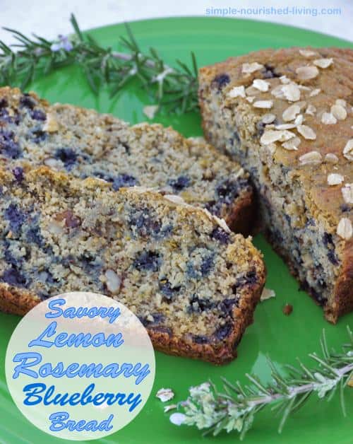 Savory Lemon Rosemary Blueberry Bread slices on green plate with fresh rosemary.