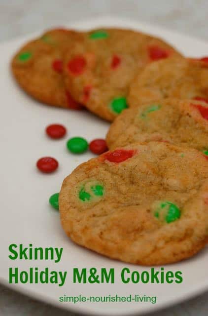 Skinny holiday m&m cookies with red and green M and M's on white plate.