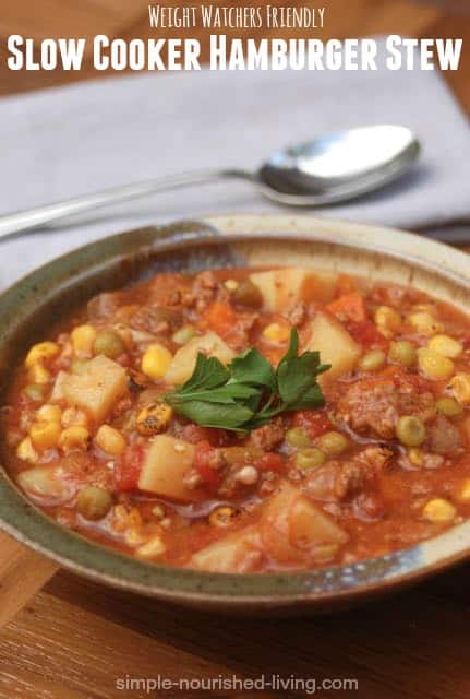 Weight Watchers Slow Cooker Hamburger Stew with potatoes, corn and peas in ceramic bowl.