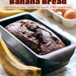 Double Chocolate Banana Bread in loaf pan on table with bananas and eggs in a carton