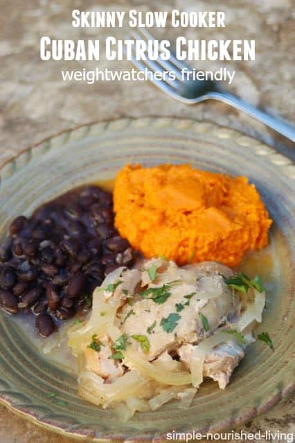 Cuban citrus chicken on dinner plate with mashed sweet potatoes and black beans.
