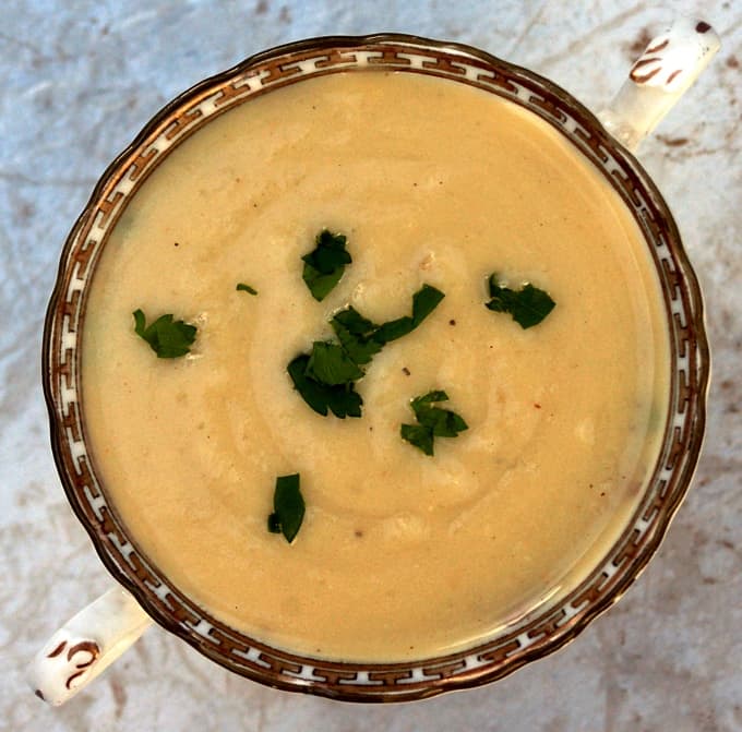 Creamy Artichoke Potato Soup topped with chopped parsley