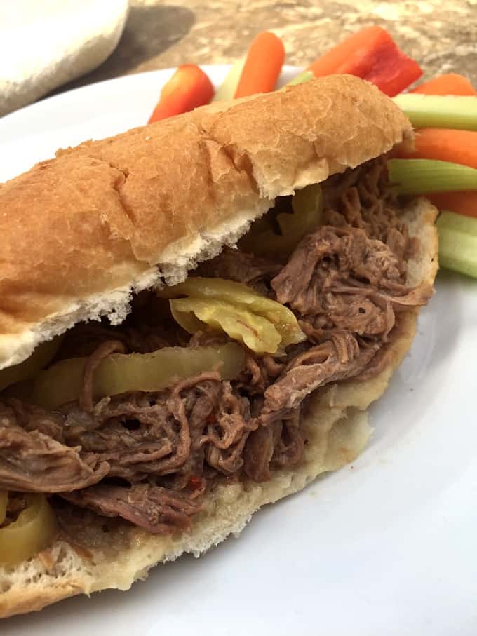 Shredded Italian Pepperoncini Beef Sandwich with carrot and celery sticks