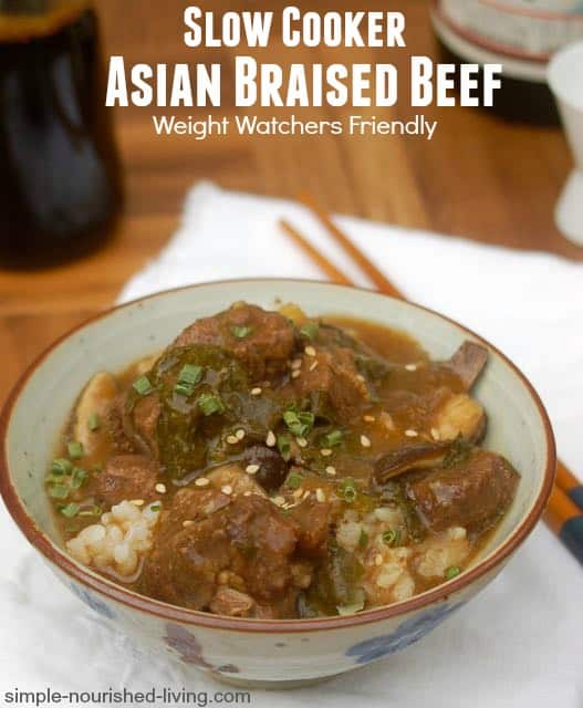 Slow cooker asian braised beef over rice in bowl with chopsticks.