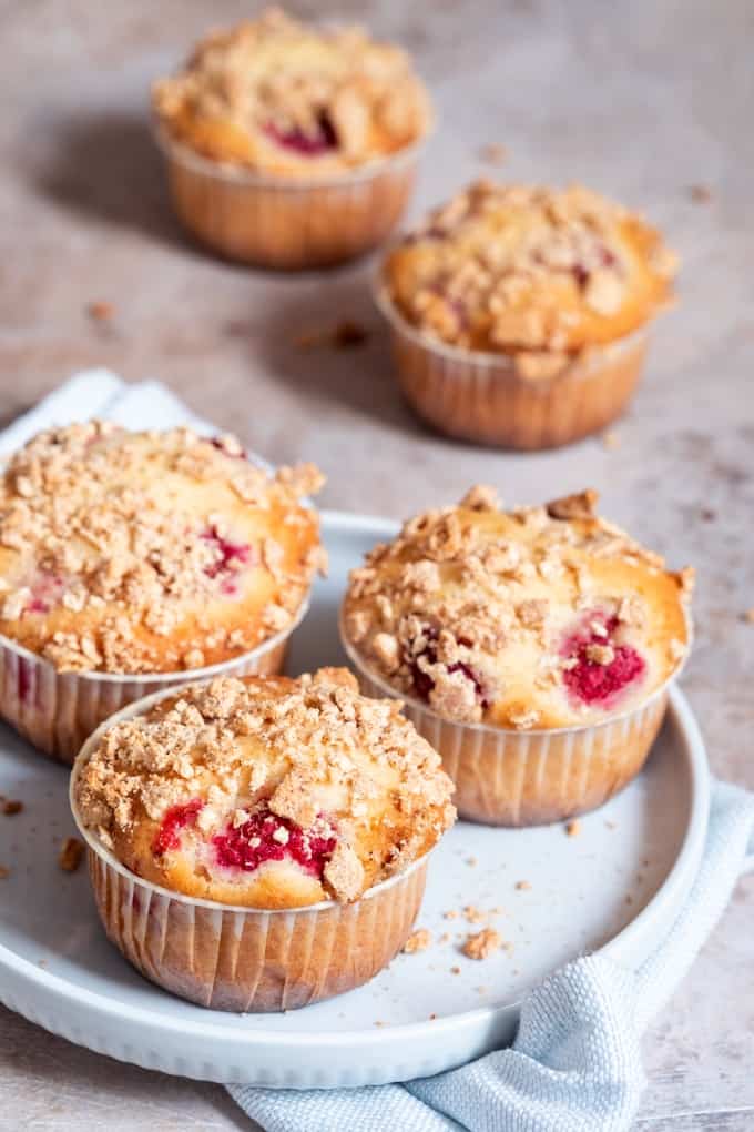 Fresh homemade strawberry streusel muffins on blue plate