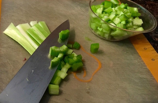 Slicing celery on plastic flexible cutting board