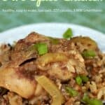 Slow cooker five spice chicken over wild rice on white dinner plate.