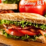 closeup of blt on toast with tomato in backgroud