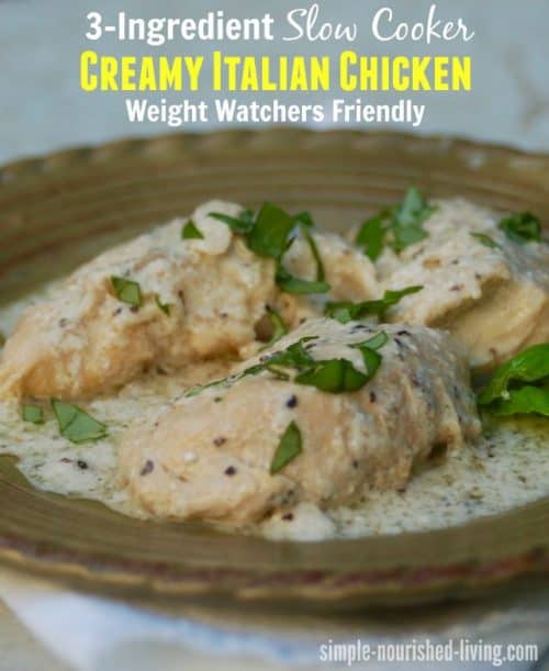 3-Ingredient Slow Cooker Creamy Italian Chicken topped with chopped basil on green ceramic plate.