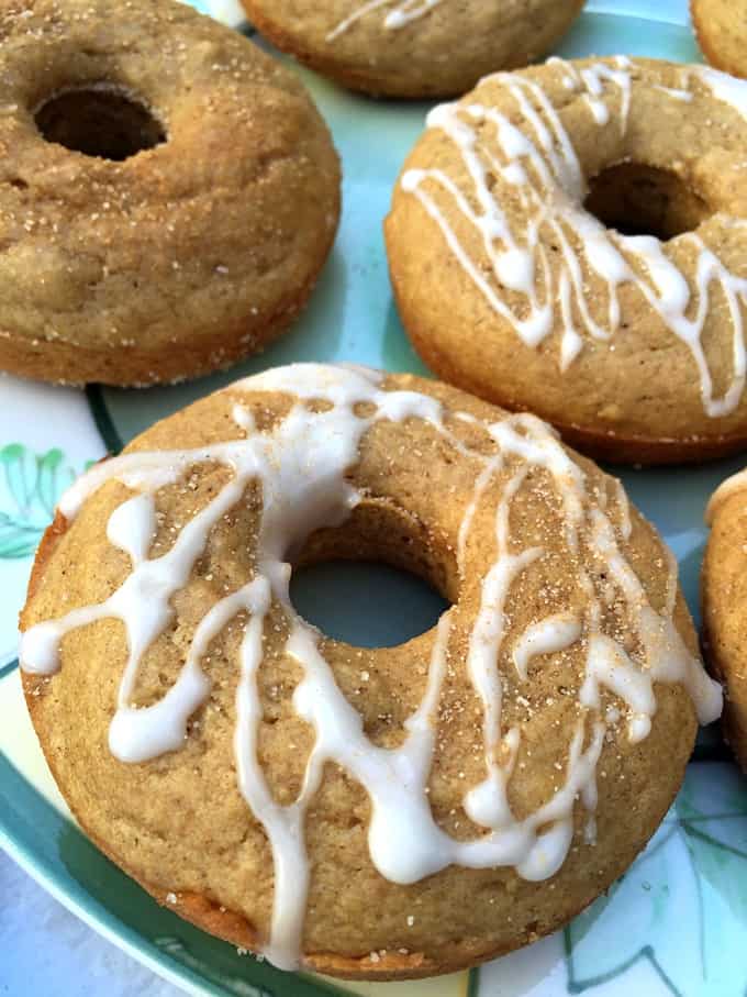 Platter of baked apple cinnamon doughnuts, so with icing and some plain.