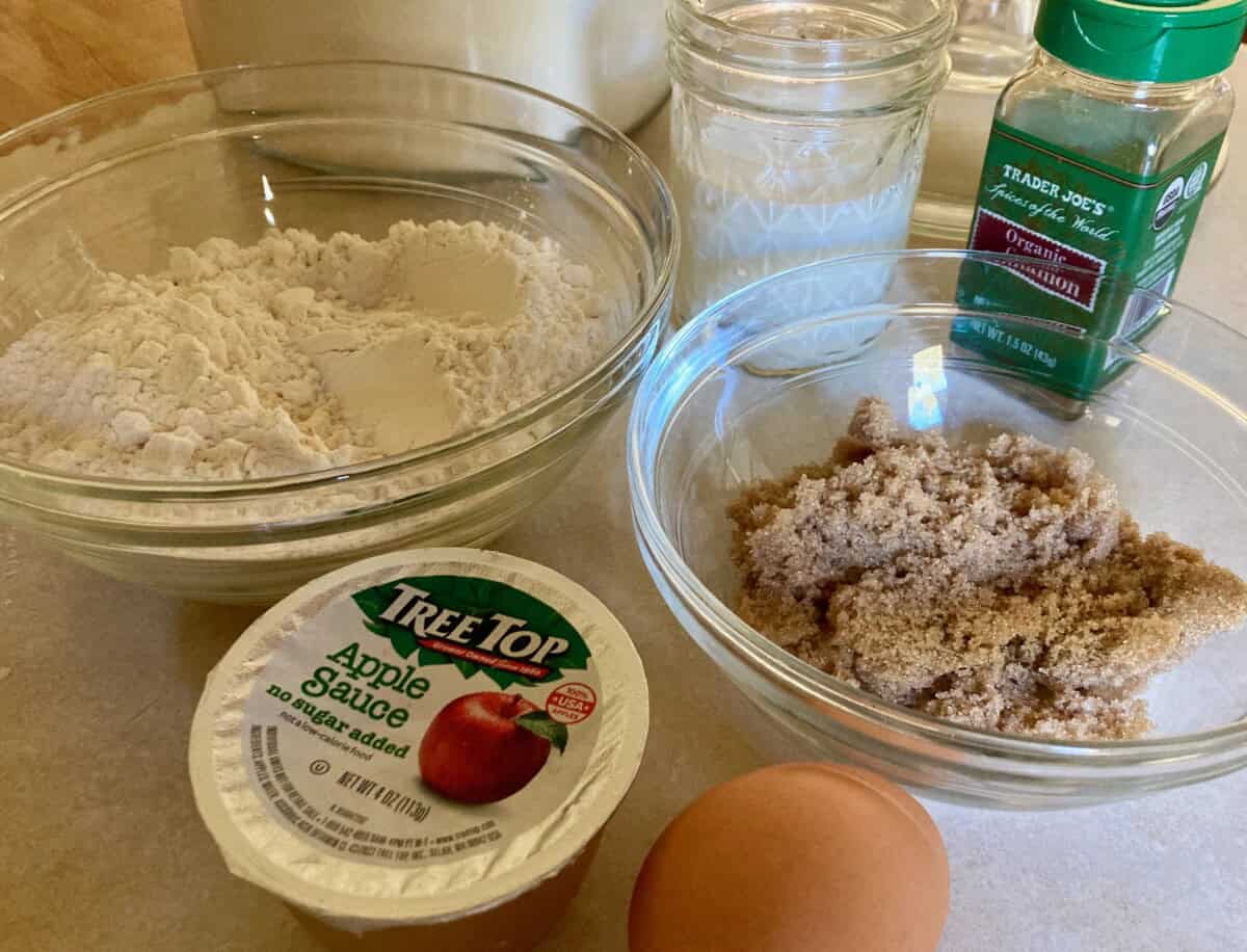 Flour, brown sugar, applesauce, egg and milk on counter.