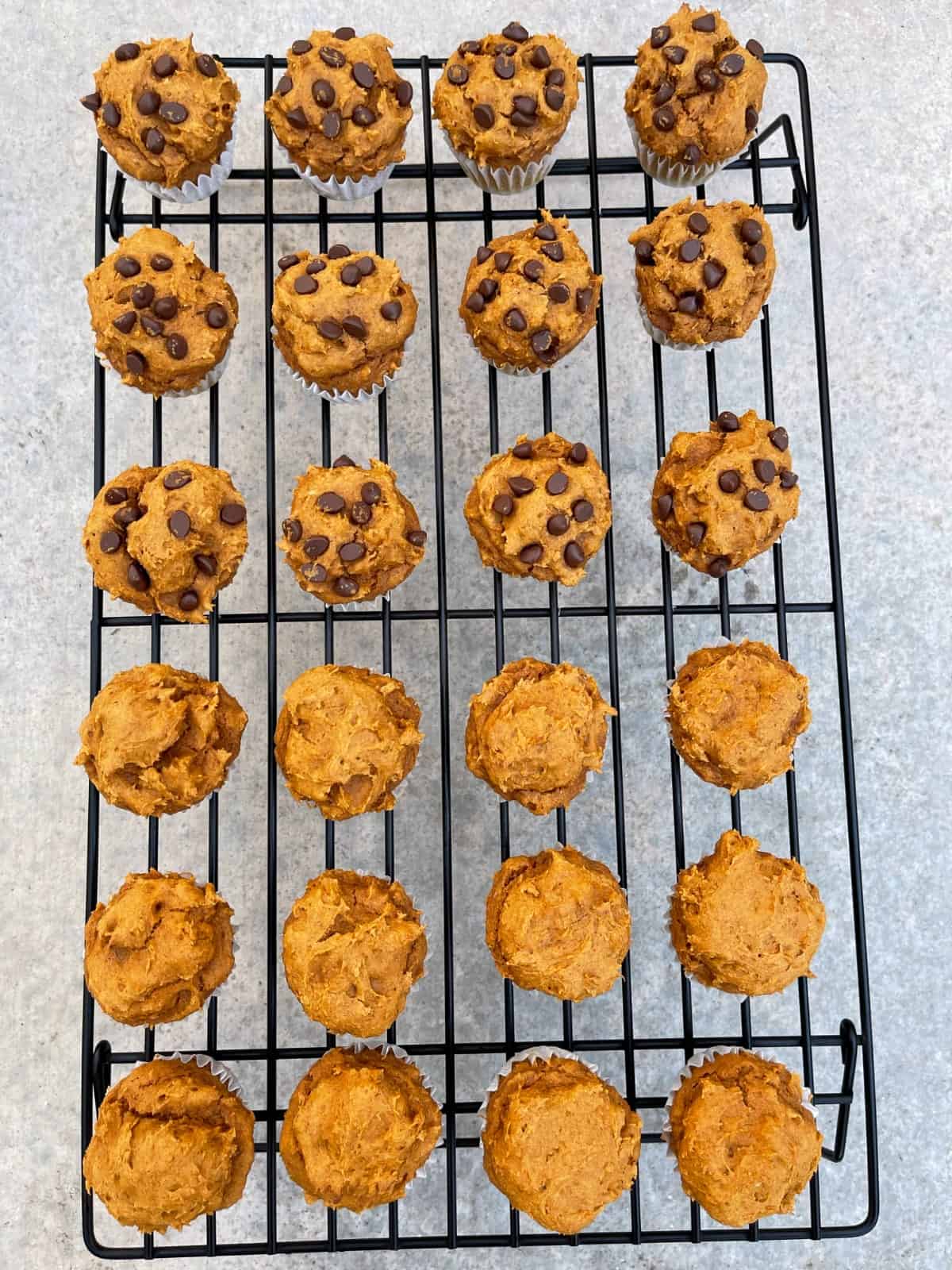 Pumpkin spice cake mix muffins cooling in wire rack.