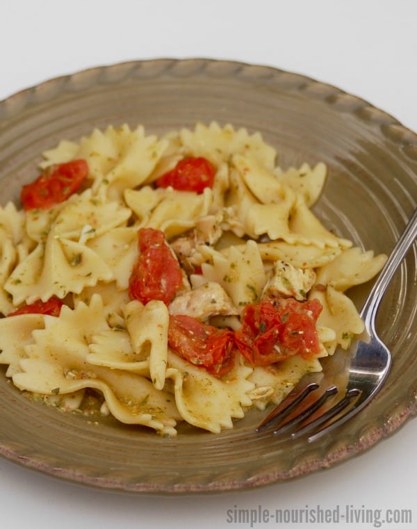 Easy, Healthy 4-Ingredient Pasta with Pesto and Tomatoes on dinner plate with fork.