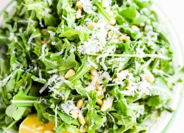 Simple Arugula Salad with Sunflower Seeds and Parmesan close up from above