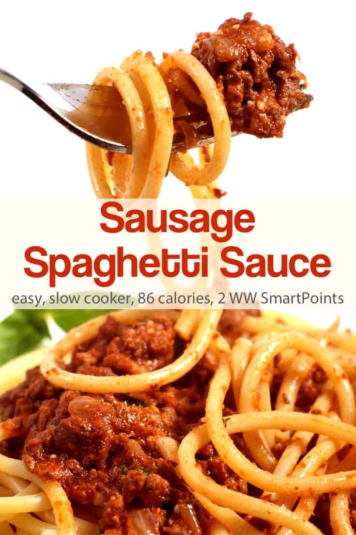 Sausage spaghetti sauce over plate of spaghetti.