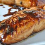 Honey Glazed Salmon on white plate from the side close up