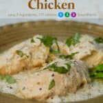 Slow cooker 3-ingredient creamy italian chicken garnished with fresh chopped basil on serving platter.