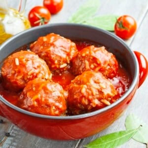 Meatballs with rice and tomato sauce in a red pot