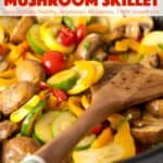 Zucchini, mushrooms and tomatoes in skillet with wooden spatula.