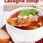 Bowl of lasagna soup topped with cheese and lasagna soup with fresh bread on the side