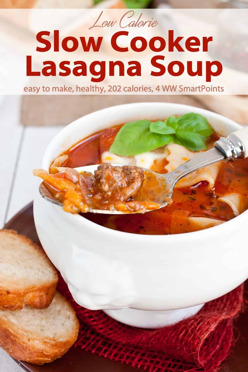 Bowl of lasagna soup topped with cheese and lasagna soup with fresh bread on the side