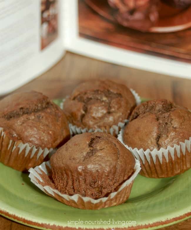 Chocolate Banana Muffins on Green Ceramic Plate with Cookbook in Background
